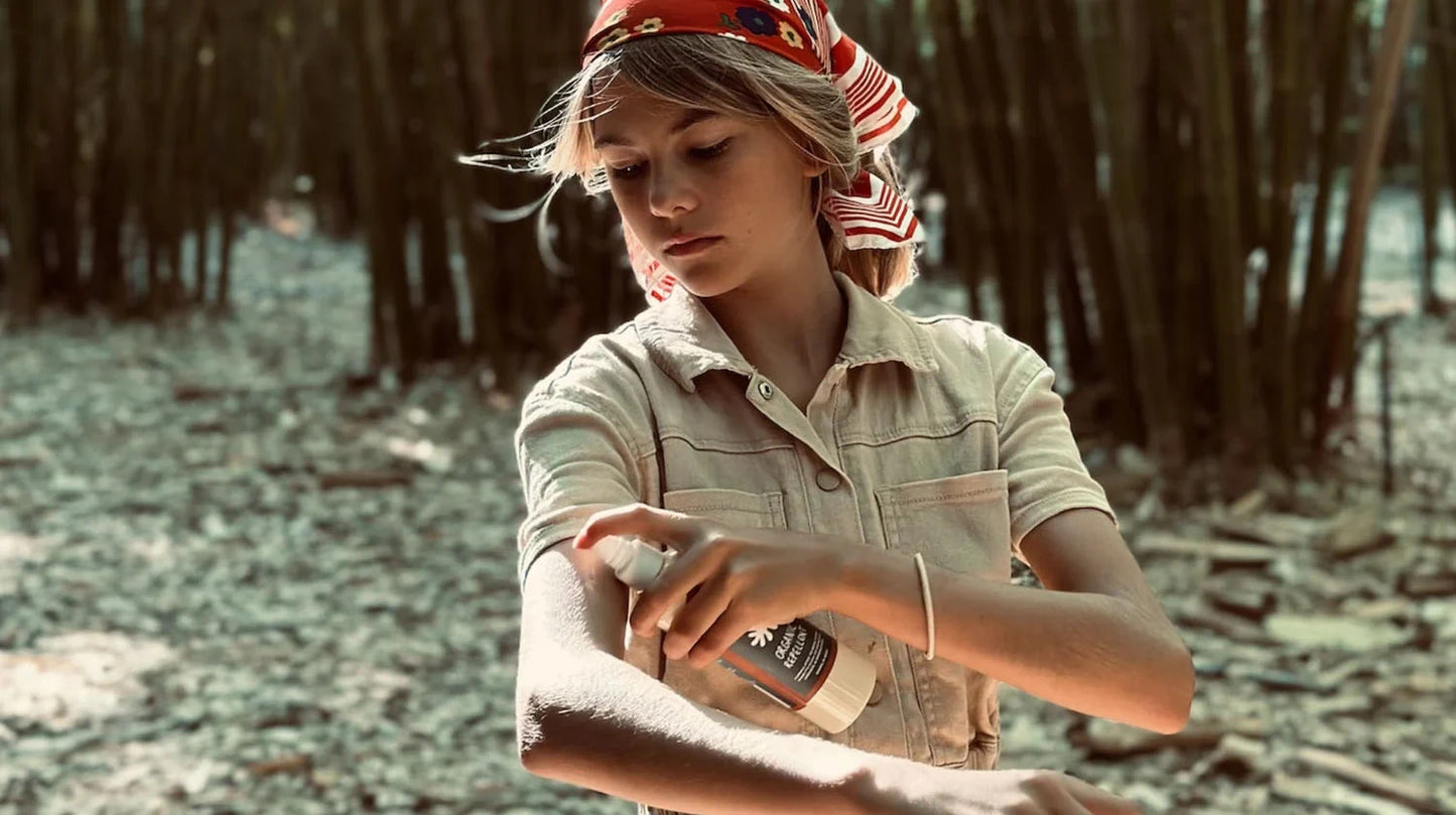 Girl using Aurapel natural insect repellant outside in forest