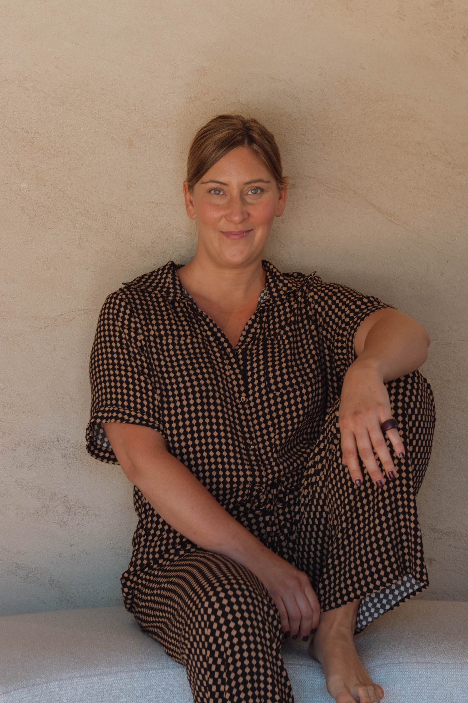 Katherine Smith, CEO of Aurapel, sitting on cushion