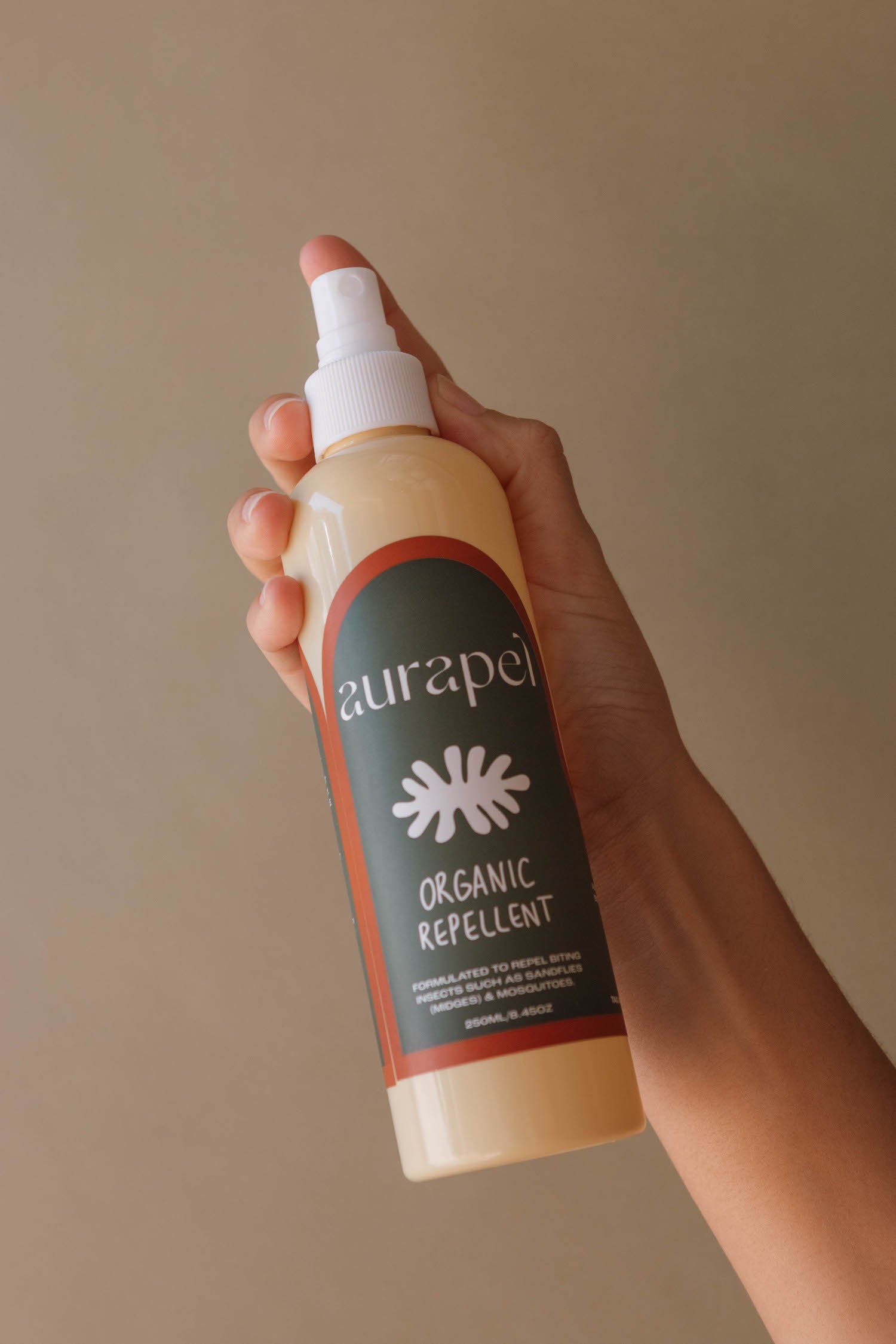 Hands holding Aurapel 250ml product